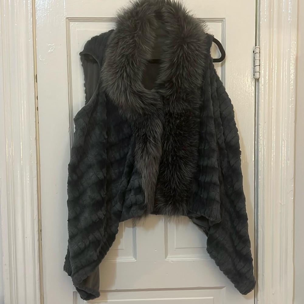 Gorgeous faux fur vest in exquisite gray with a clip front enclosure.
